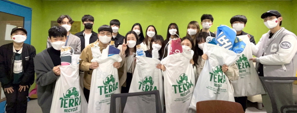 중앙대학교 환경동아리 '지구인' 회원들이 테라 맥아 포대를 활용해 대학가에서 수거한 현수막들을 들고 있다.(사진제공=하이트진로)