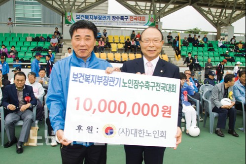 ▲이 심 대한노인회장(오른쪽)이 김길문 전국장수축구진흥회장에게 후원금을 전달하고 있다.